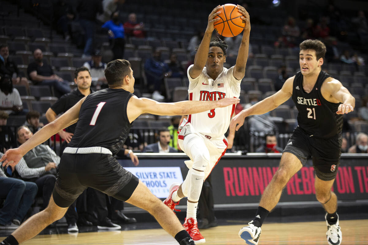 UNLV Rebels forward Donovan Williams (3) gains control of the ball while Seattle Redhawks guard ...