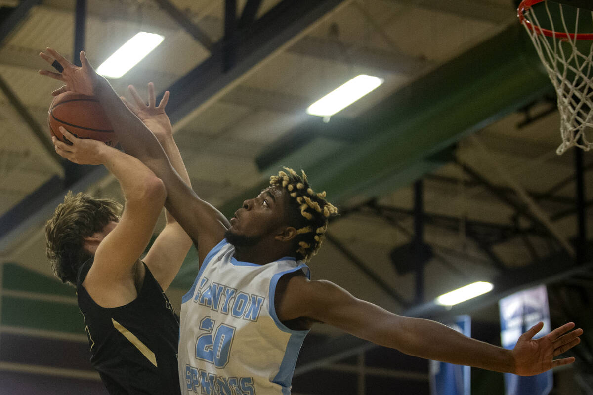 Canyon Springs forward Lorenzo Moore (20) blocks a shot attempted by Spring Valley forward Cars ...