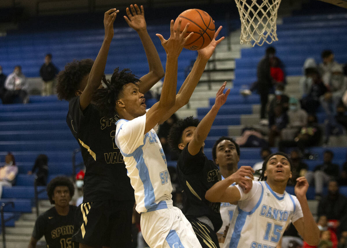 Canyon Springs forward Bryant Legardy (2) shoots against Spring Valley forward Heyab Shemeles ( ...