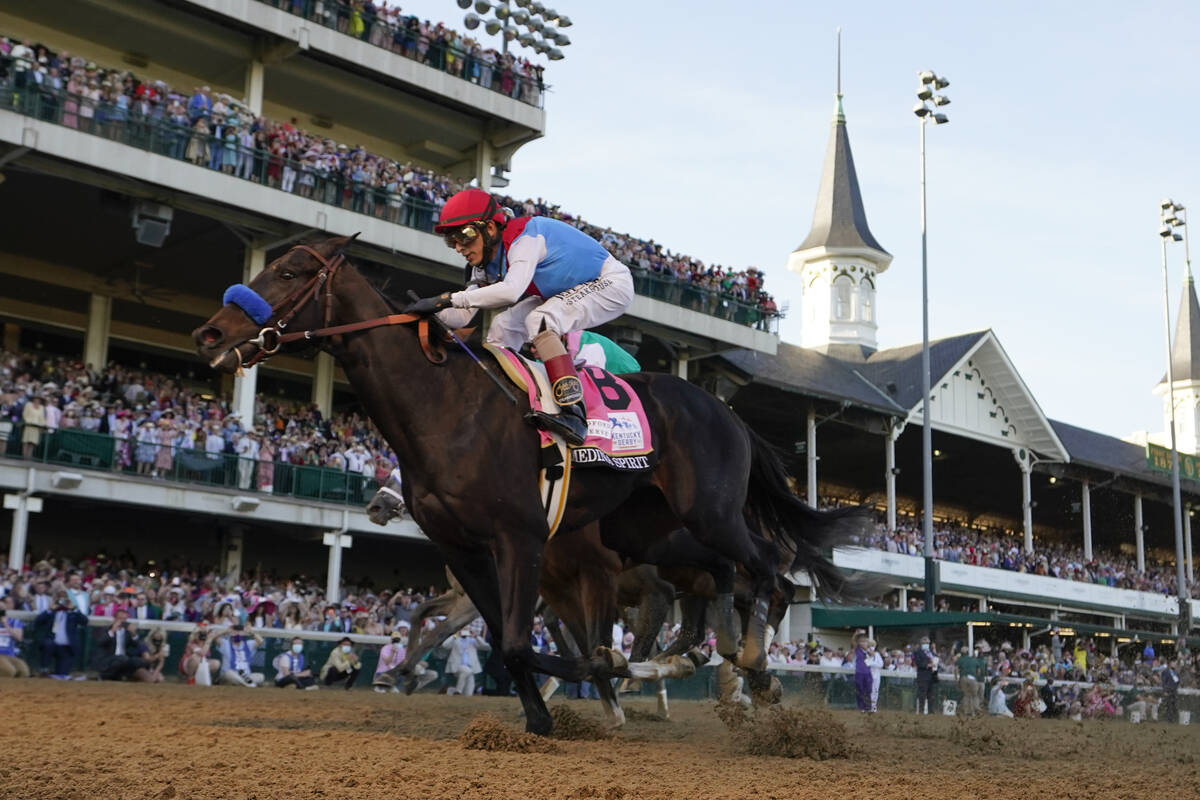 FILE - John Velazquez rides Medina Spirit across the finish line to win the 147th running of th ...