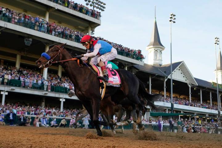 FILE - John Velazquez rides Medina Spirit across the finish line to win the 147th running of th ...