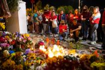 People attend a vigil for Tina Tintor and her dog Max at a memorial on Rainbow Boulevard and Sp ...