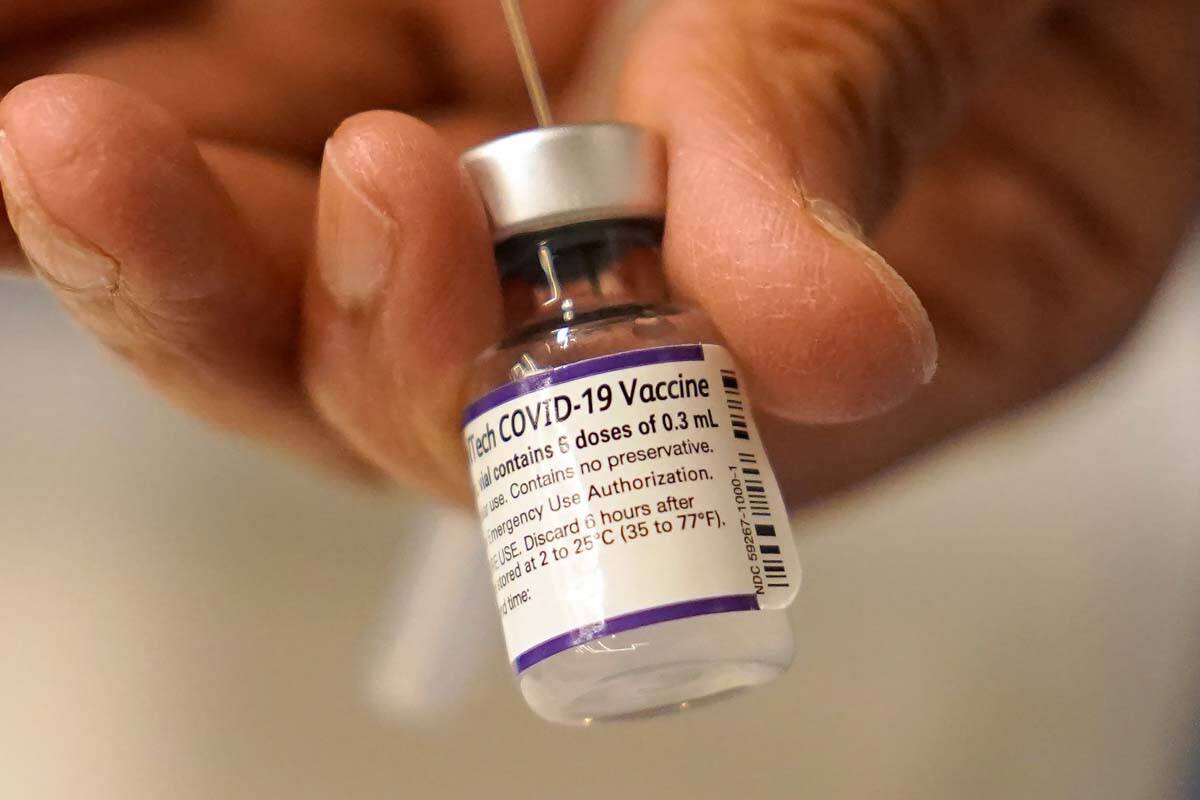Dr. Manjul Shukla transfers Pfizer COVID-19 vaccine into a syringe, Thursday, Dec. 2, 2021, at ...