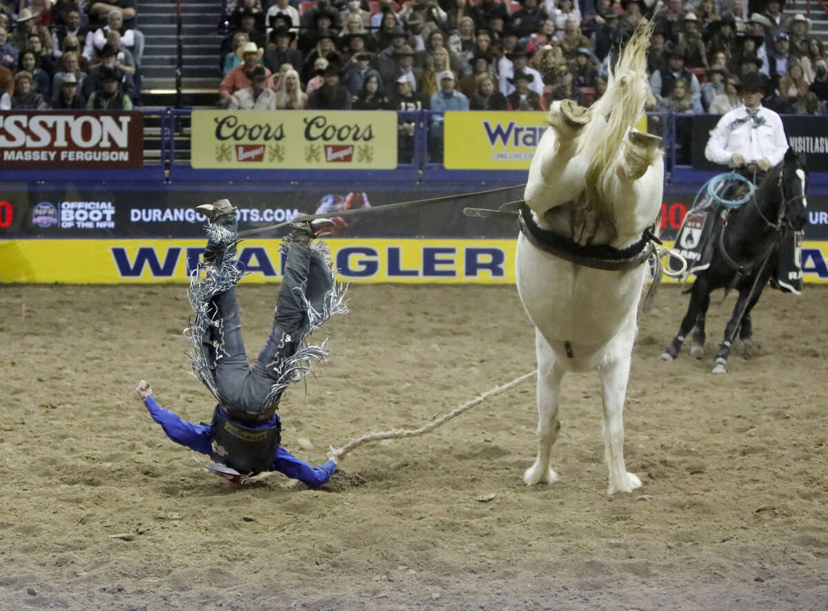 Stetson Dell Wright of Milford, Utah is thrown from his horse in the saddle bronc riding event ...