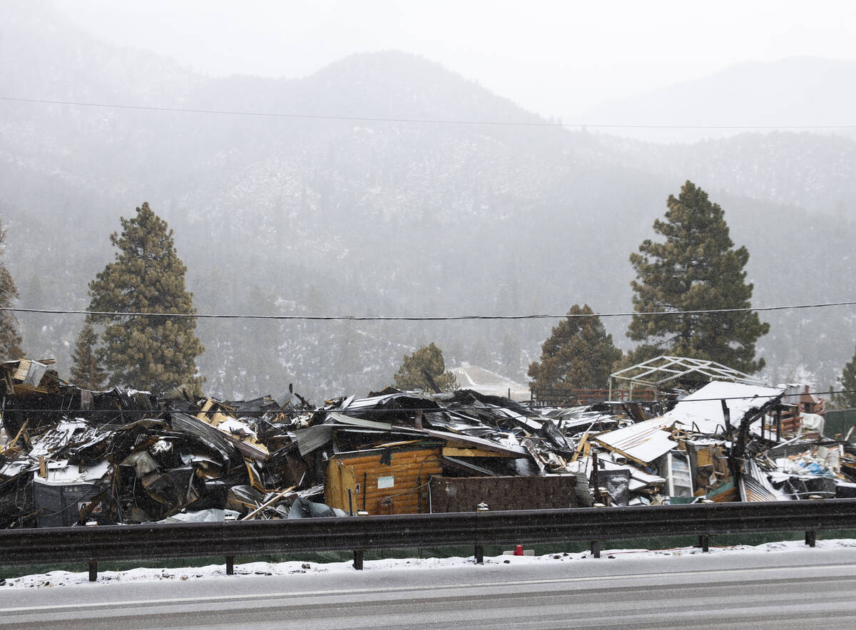 Debris of the former Mount Charleston Lodge is seen as light snow fall on the Mt. Charleston ar ...