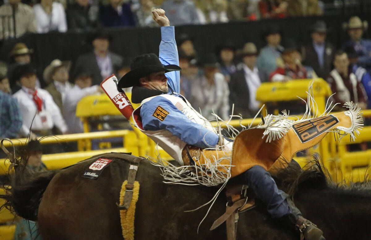 Kaycee Feild of Genola, Utah competes in the bareback riding event during the eighth go-round o ...