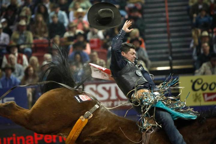 Tanner Aus of Granite Falls, Minn. loses his hat while competing in the bareback riding event d ...