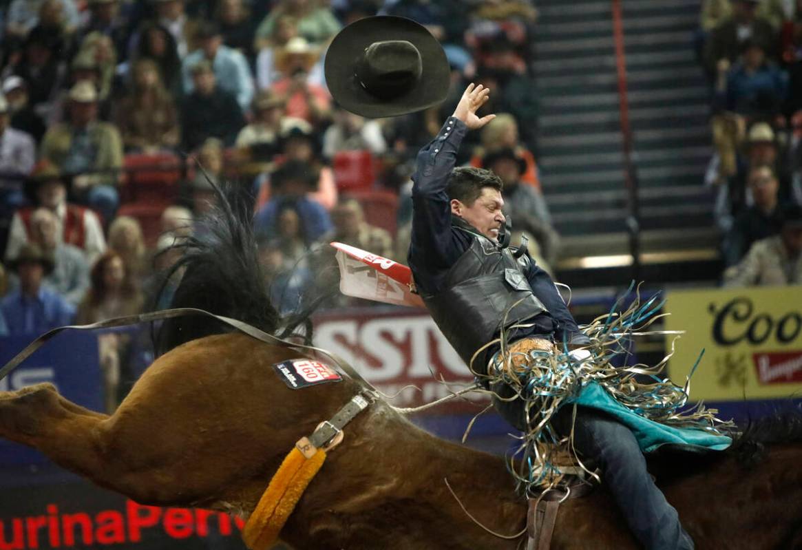 Tanner Aus of Granite Falls, Minn. loses his hat while competing in the bareback riding event d ...