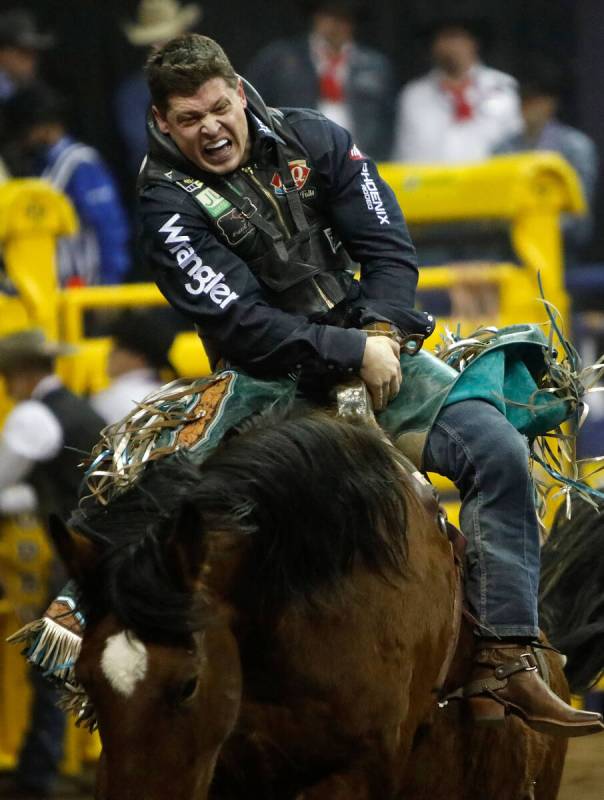 Tanner Aus of Granite Falls, Minn. competes in the bareback riding event during the eighth go-r ...