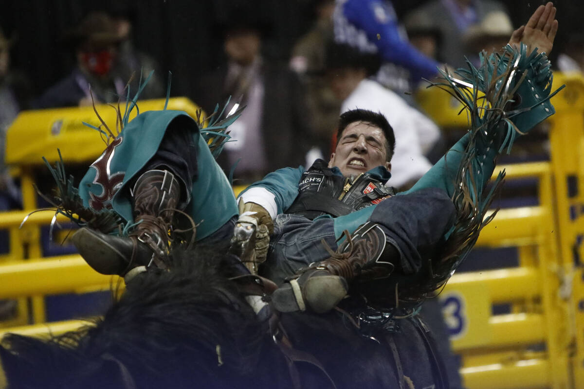 Jess Pope of Waverly, Kan. competes in the bareback riding event during the eighth go-round of ...