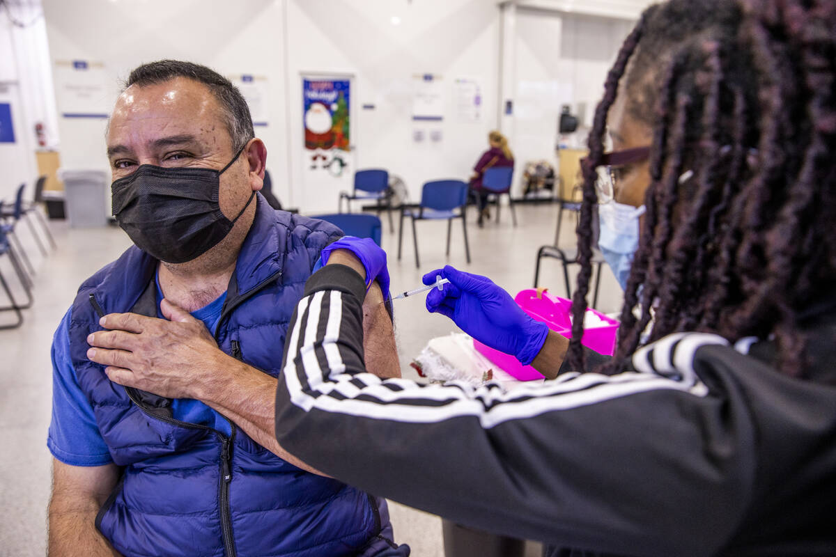 Jose Grajeda, left, is given a shot by Adwoa Fosu in the COVID-19 vaccination clinic at the Sou ...