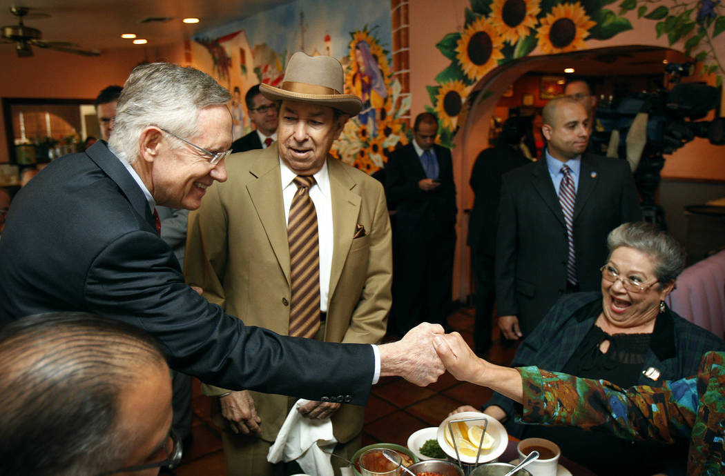 U.S. Sen. Harry Reid, D-Nev., left, is accompanied by Eddie Escobedo, publisher of El Mundo, a ...