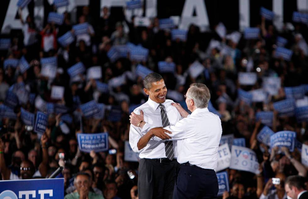 President Barack Obama embraces U.S. Senator Harry Reid, D-Nev., during a rally at Orr Middle S ...