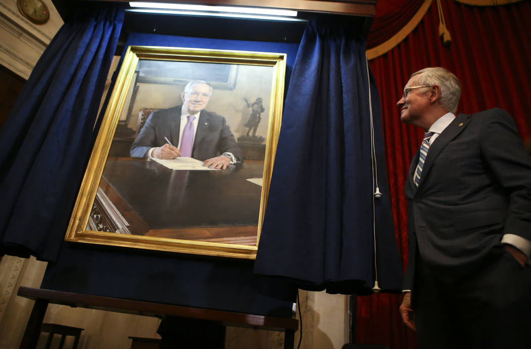 U.S. Sen. Harry Reid, D-Nev., looks at a portrait of himself after it was unveiled during a cer ...
