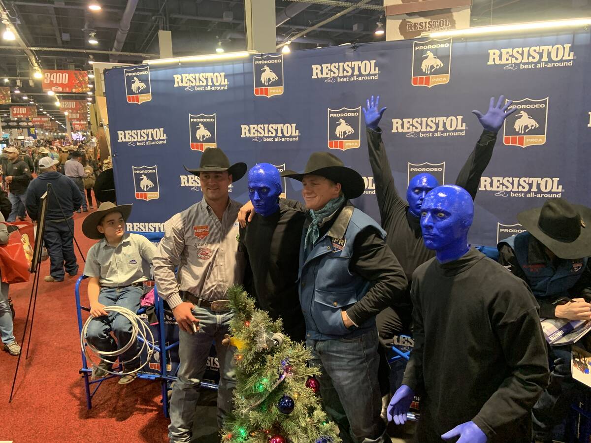 Wrangler NFR contestants [TO BE ID'D SHORTLY; DON'T HAVE NAMES YET] take a break from an autogr ...