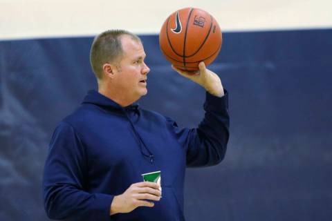 Bishop Gorman basketball head coach Grant Rice, right, holds a ball during a basketball practic ...