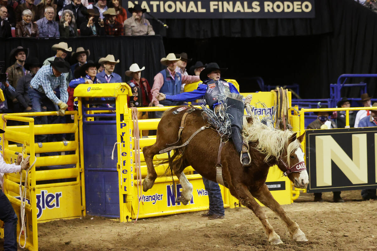 Stetson Wright of Milford, Utah, competes in the saddle bronc riding event during the ninth go- ...
