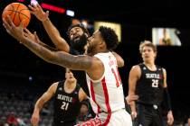 UNLV Rebels forward Royce Hamm Jr. (14) and Seattle Redhawks guard Cameron Tyson (5) compete fo ...