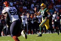 Green Bay Packers quarterback Aaron Rodgers pulls the ball down and runs for a touchdown during ...