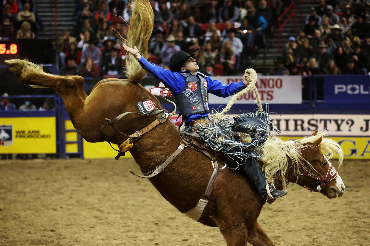 Stetson Wright of Milford, Utah, competes in the saddle bronc riding event during the ninth go- ...