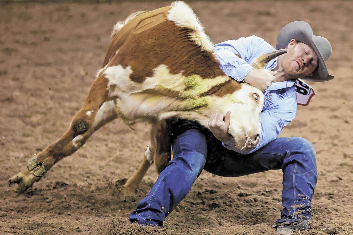 Stetson Jorgensen of Blackfoot, Idaho, competes in the steer wrestling event during the ninth g ...