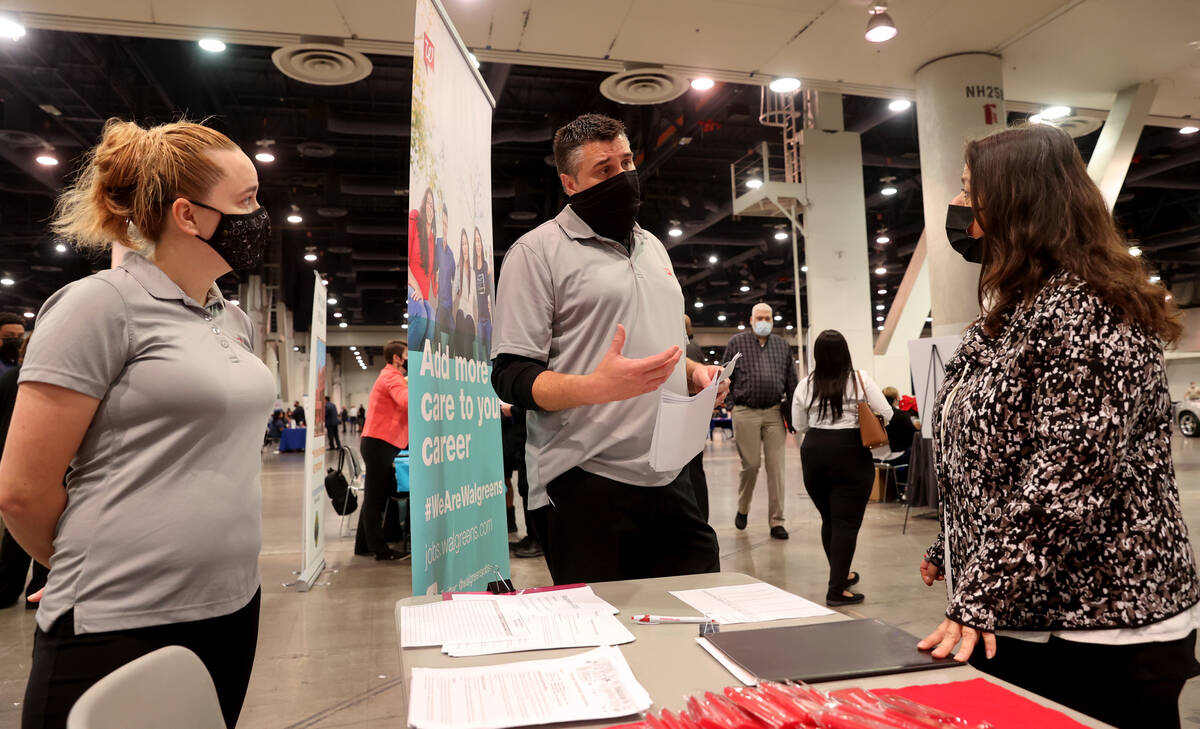 Job seeker AnneMarie Lerate of North Las Vegas, right, talks to Brad Driscoll and Jennifer Broo ...