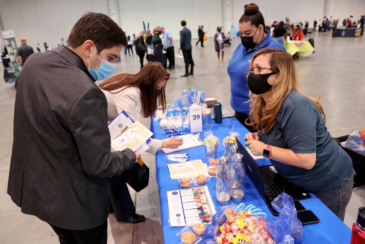 Job seeker Michael Ramos of Las Vegas, left, talks to Sarah Bell of MasterCorp during JobFest 2 ...