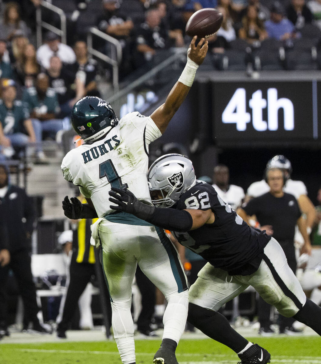 Philadelphia Eagles quarterback Jalen Hurts (1) is sacked by Raiders defensive end Solomon Thom ...