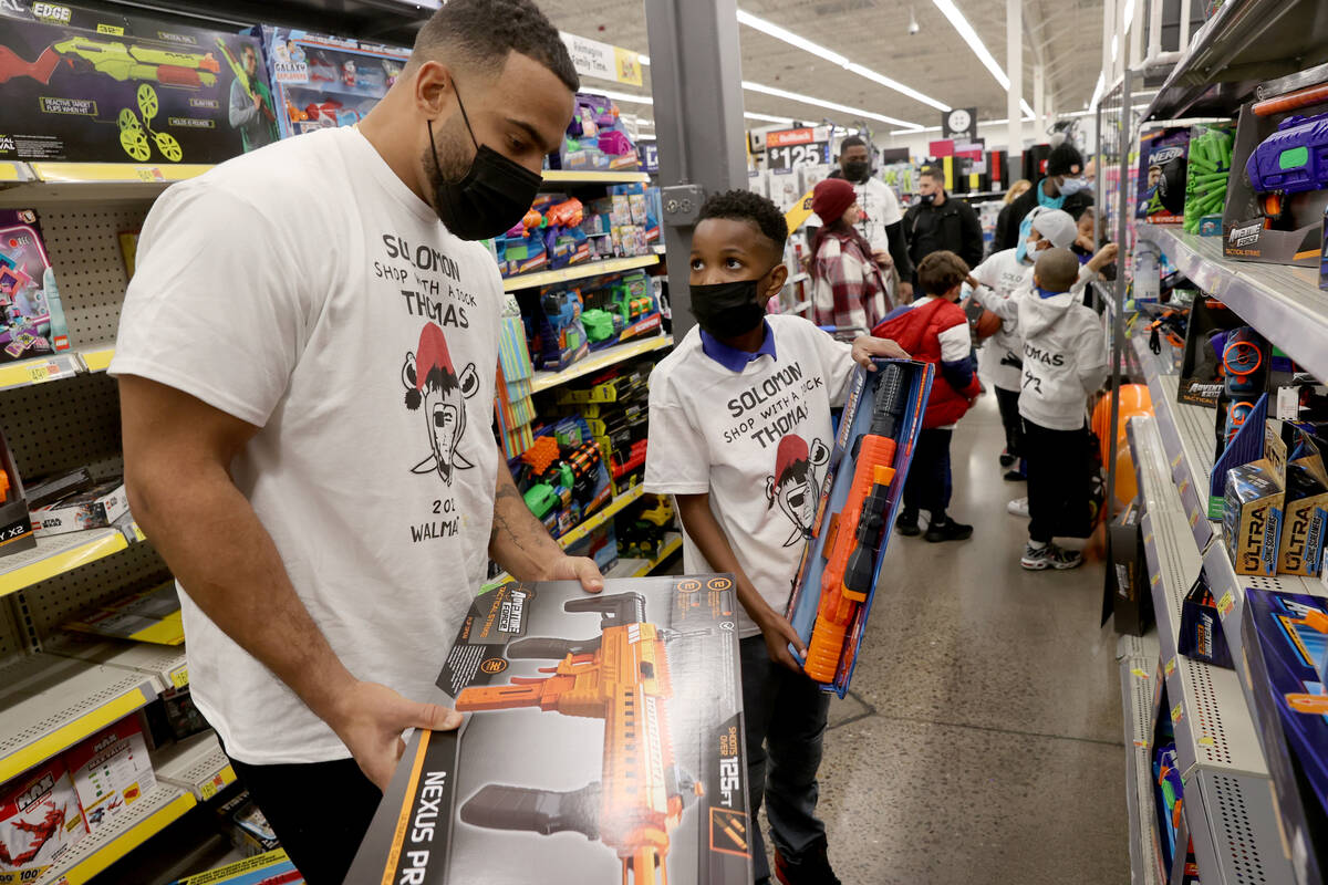 Raiders defensive tackle Solomon Thomas shops with Nickolas Brown, 10, during his "Shop with a ...