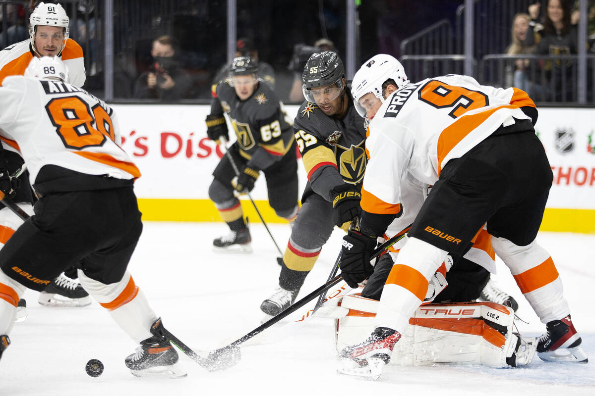 Golden Knights right wing Keegan Kolesar (55) fights for the puc while Flyers right wing Cam At ...