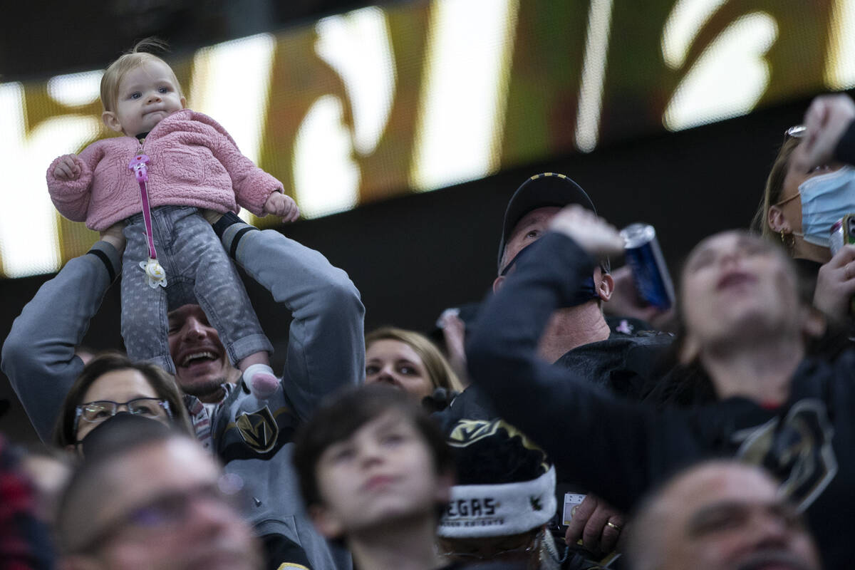 A young Golden Knights fan is held up among the cheering crowd after Golden Knights left wing M ...