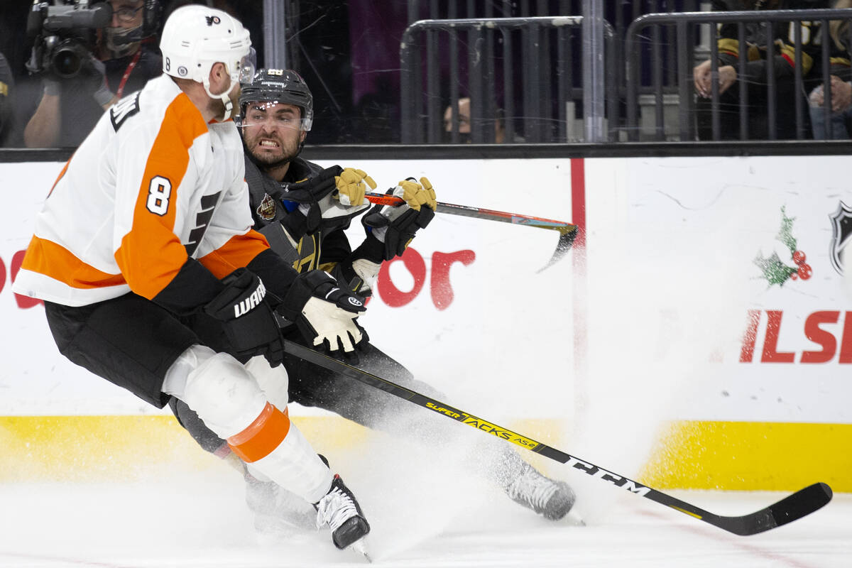 Golden Knights left wing William Carrier (28) collides with Flyers defenseman Kevin Connauton ( ...