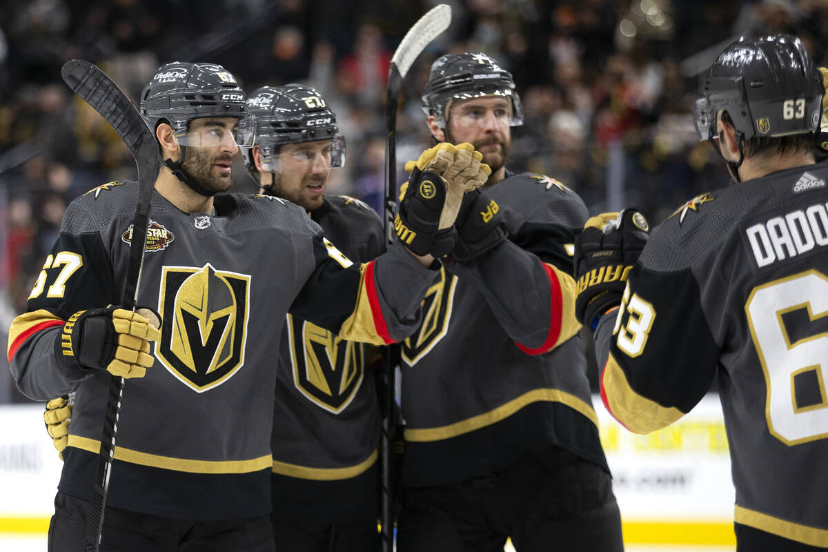 Golden Knights left wing Max Pacioretty (67) is congratulated by defenseman Shea Theodore (27), ...
