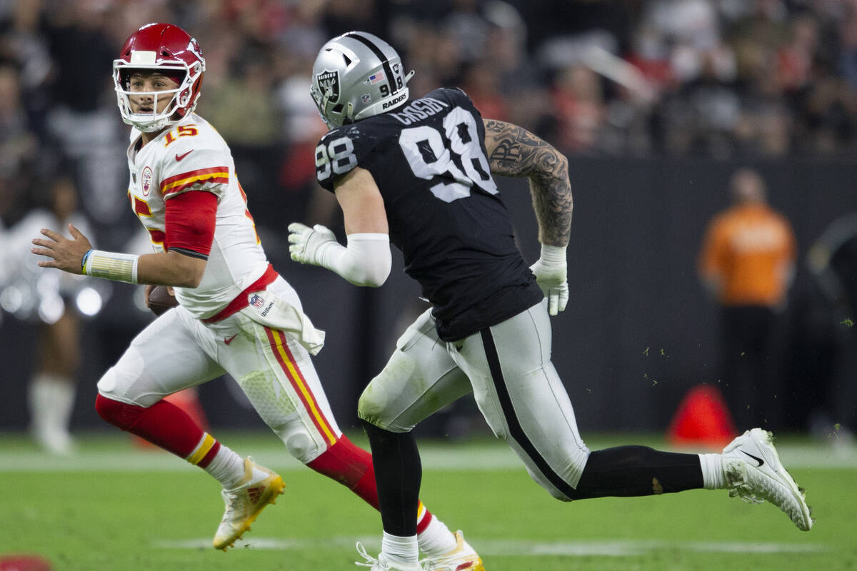 Kansas City Chiefs quarterback Patrick Mahomes (15) tries to escape pressure from Raiders defen ...