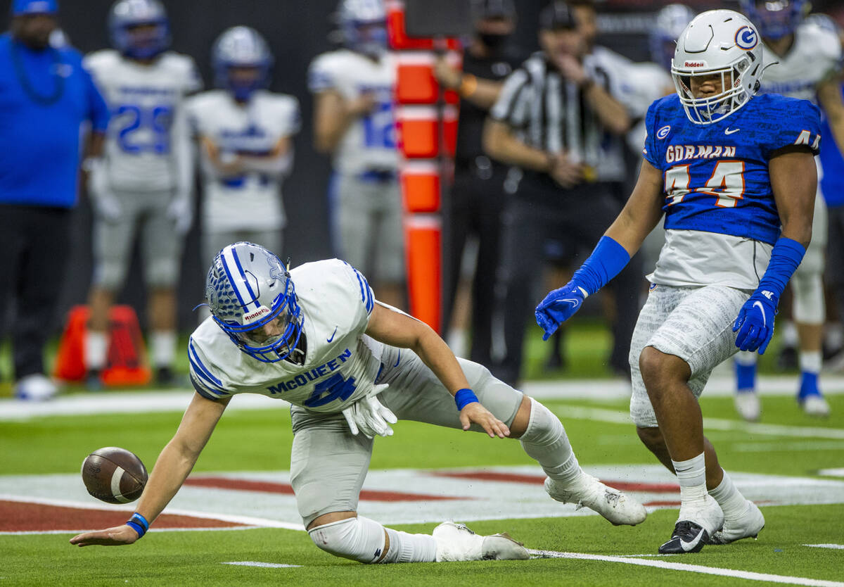 McQueen quarterback Robert Snelling (4) fumbles the ball as Bishop Gorman defensive lineman Aid ...