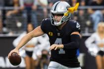 Raiders quarterback Derek Carr (4) scrambles as a penalty is thrown during an NFL football game ...