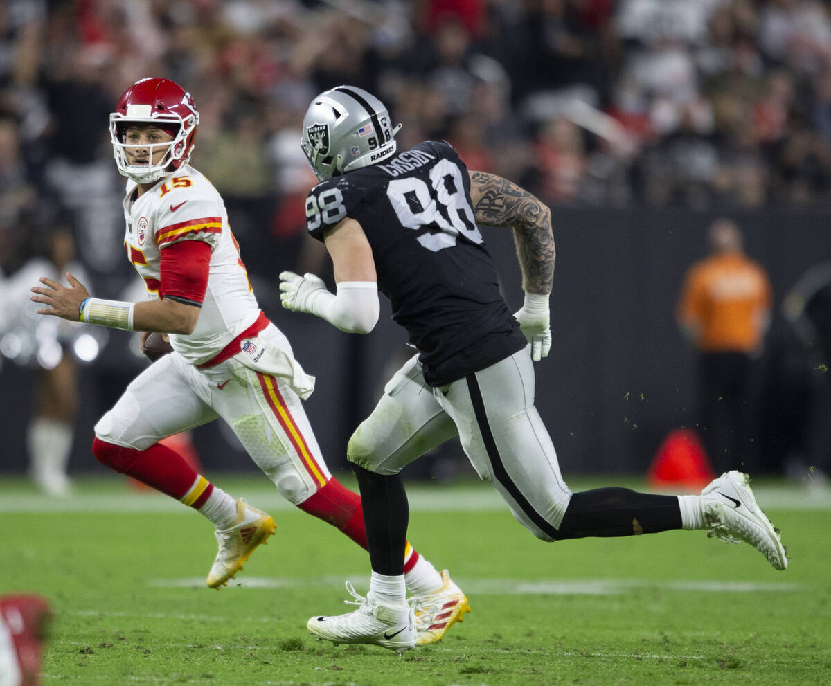 Kansas City Chiefs quarterback Patrick Mahomes (15) tries to escape pressure from Raiders defen ...