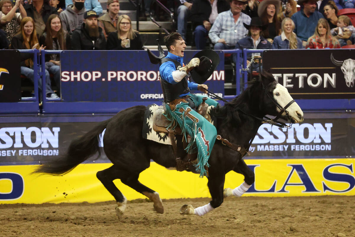 Jess Pope of Waverly, Kan., celebrates his win in the bareback riding event in the National Fin ...