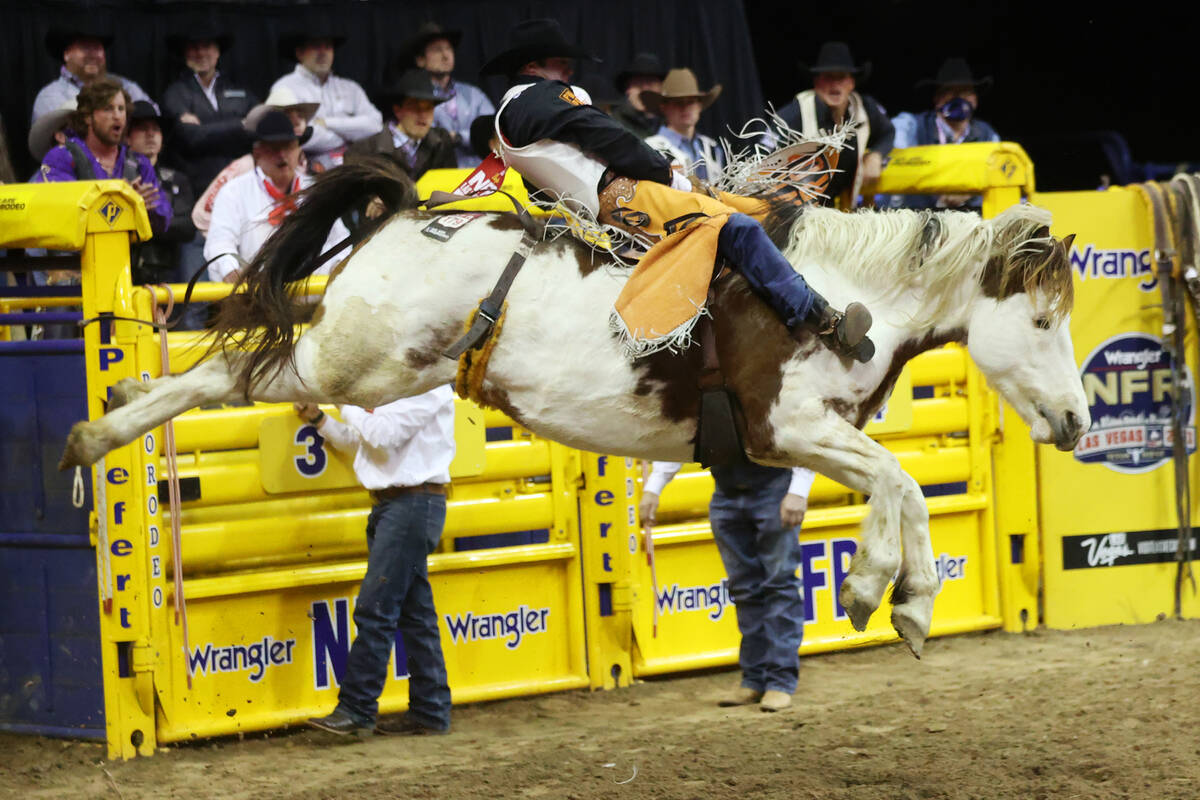 Kaycee Feild of Genola, Utah, competes in the bareback riding event during the tenth go-round o ...