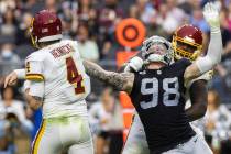 Raiders defensive end Maxx Crosby (98) puts pressure on Washington Football Team quarterback Ta ...