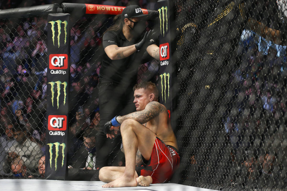 Dustin Poirier sits after losing via submission to Charles Oliveira in a lightweight mixed mart ...