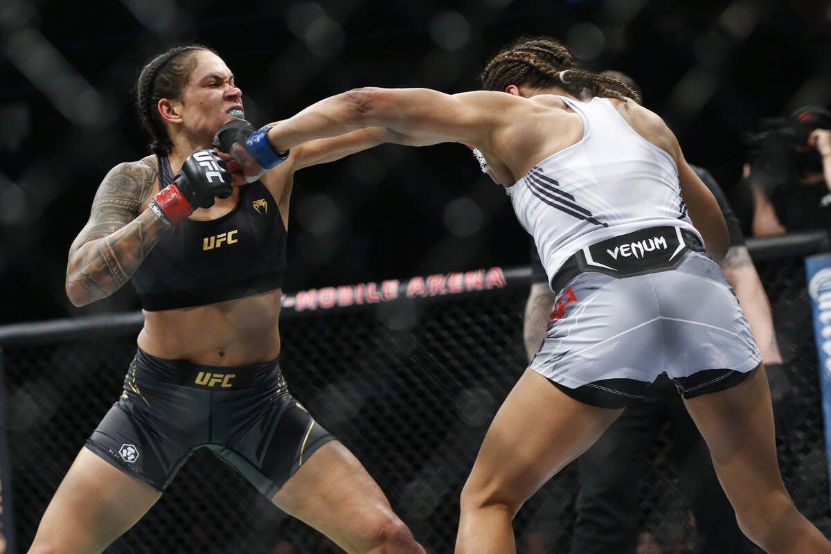 Amanda Nunes, left, fights Julianna Pena during a women's bantamweight mixed martial arts title ...