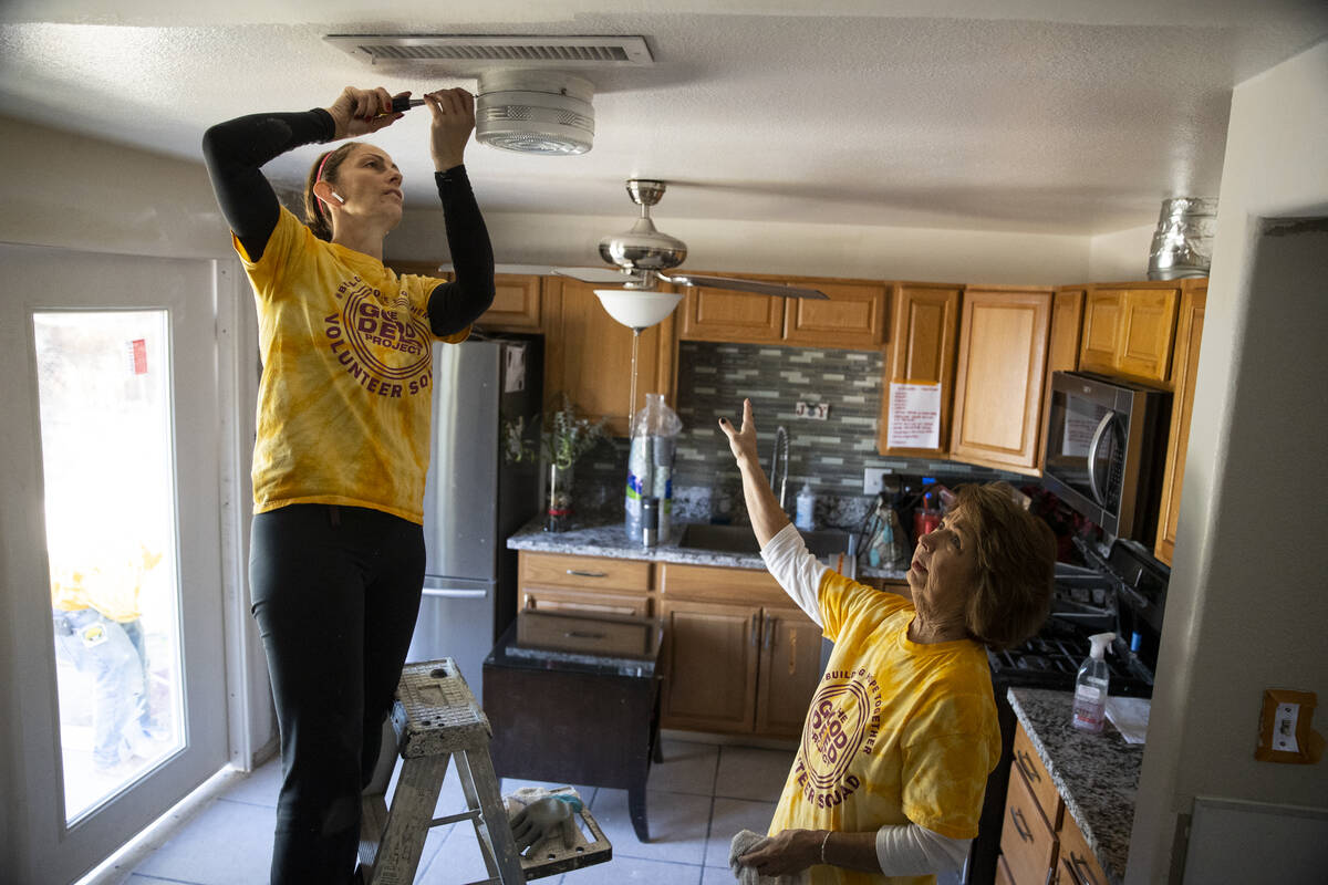 Volunteers Mary Fitzgerald, left, and her mother-in-law Marsha Dunham work in a home renovation ...