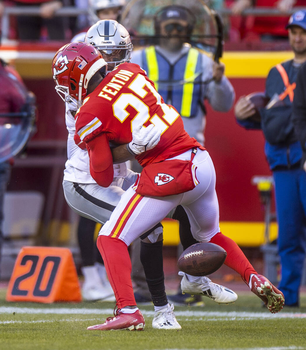 Raiders wide receiver Zay Jones (7) fumbles the ball after a hit by Kansas City Chiefs cornerba ...
