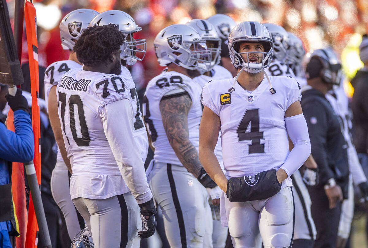 Raiders quarterback Derek Carr (4) looks to the singing and cheering Kansas City Chiefs fans du ...
