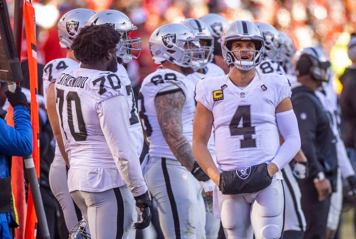 Raiders quarterback Derek Carr (4) looks to the singing and cheering Kansas City Chiefs fans du ...