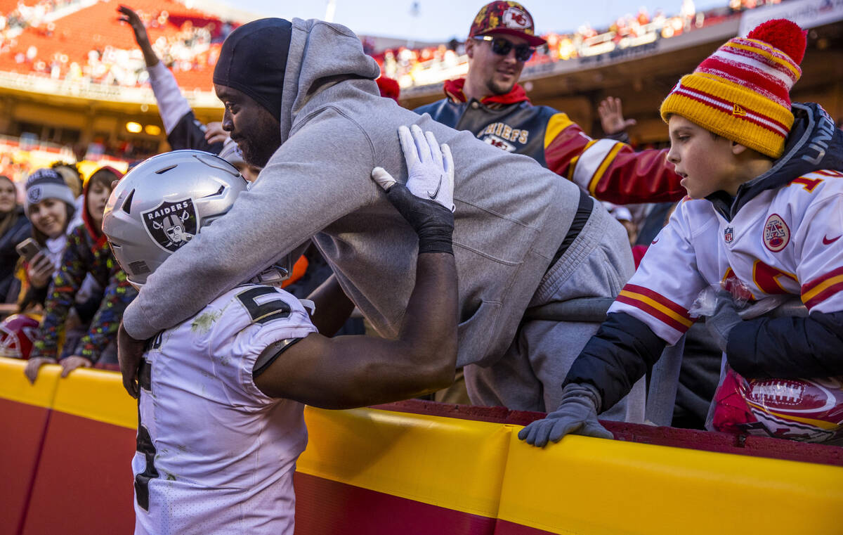 Raiders linebacker Divine Deablo (5) gets a hug from a fan in the stand after losing to the Kan ...