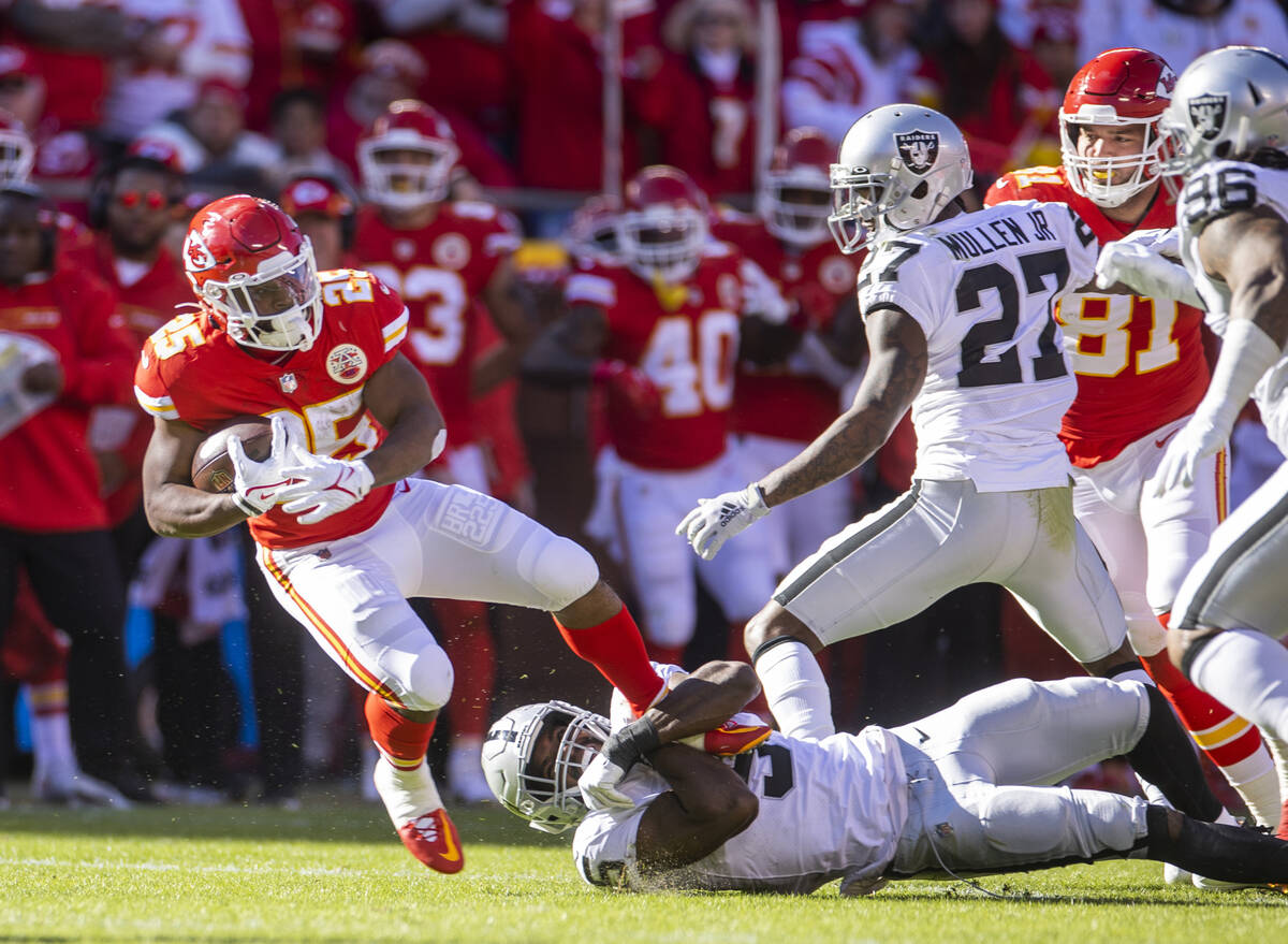 Kansas City Chiefs running back Clyde Edwards-Helaire (25) is caught by Raiders linebacker Divi ...