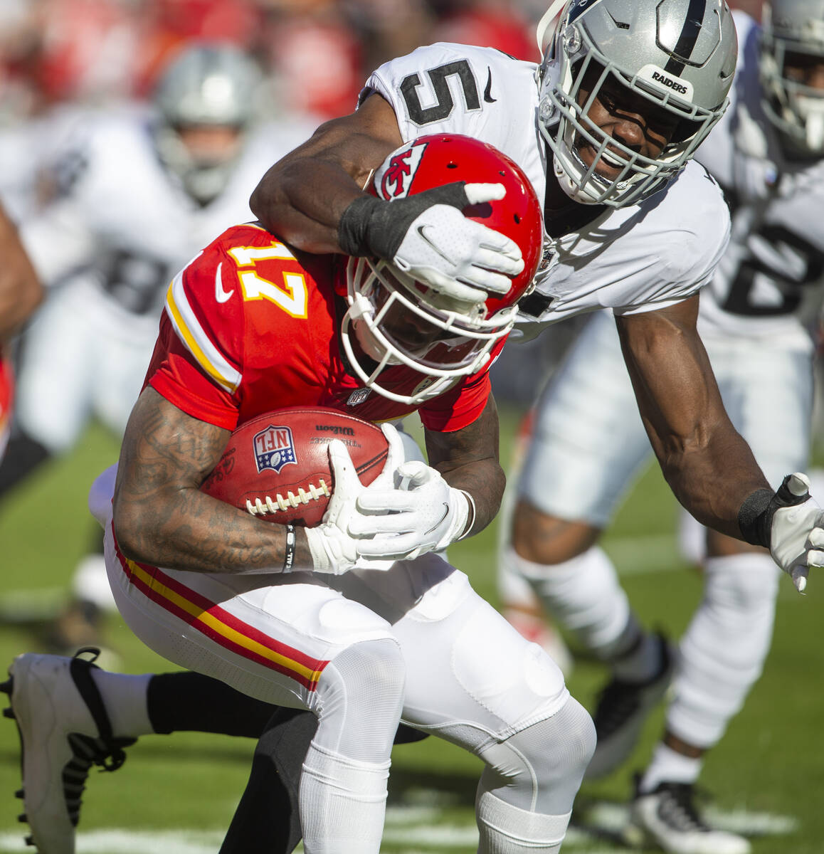 Kansas City Chiefs wide receiver Mecole Hardman (17) is tackled by Raiders linebacker Divine De ...