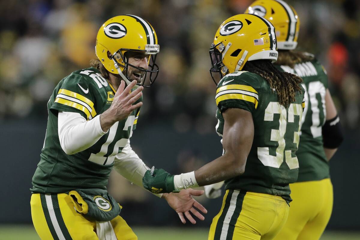Green Bay Packers' Aaron Rodgers celebrates an Aaron Jones' touchdown run during the second hal ...